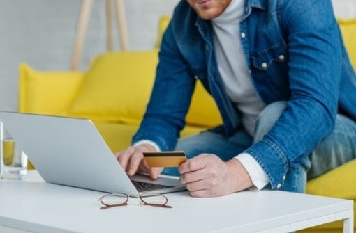 man-making-online-payment-with-credit-card-and-lap